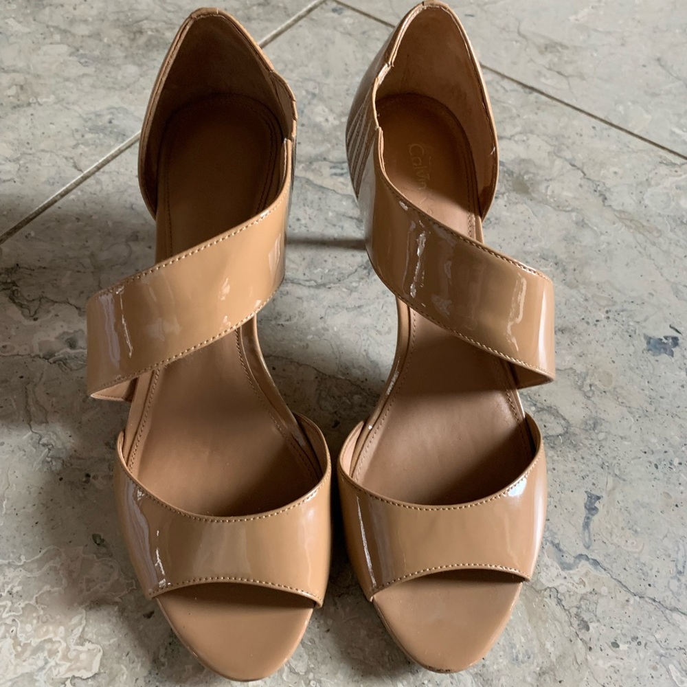 Calvin Klein nude patent leather sandals.